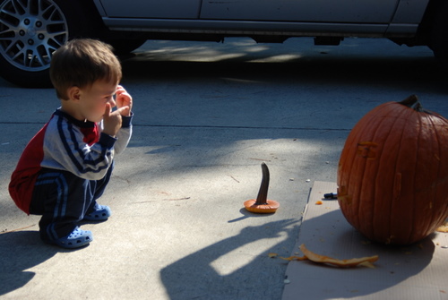 Having a conversation with Grandpa's pumpkin... this was right after he tried to feed the pumpkin.
