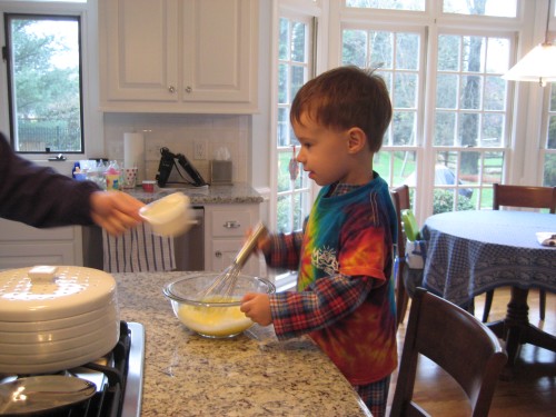 Jack helping Daddy make pancakes.  With his "rainbow shirt" on over his pj's.  I literally have to peal that shirt off of him when he's sleeping.